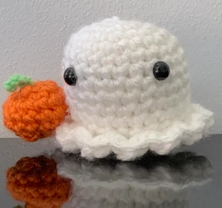 Halloween ghostie grabbing a pumpkin