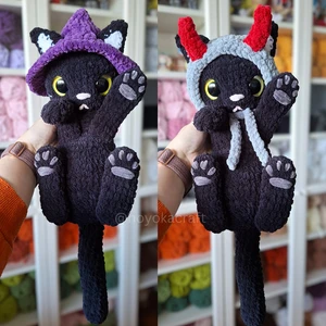 Black cat with 2 hats