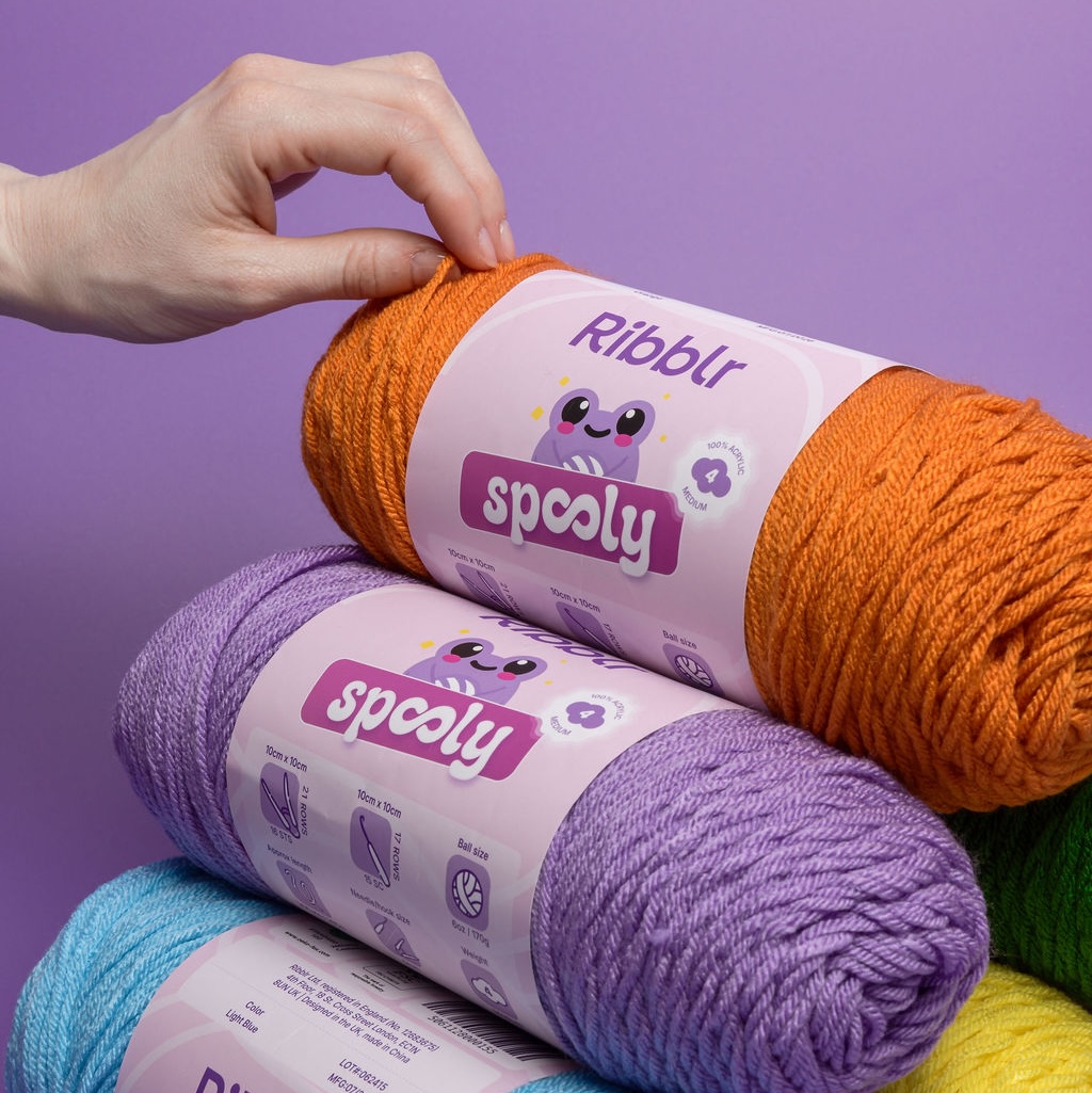 Close-up of Ribblr Spooly yarn labels showing weight, gauge and ball details